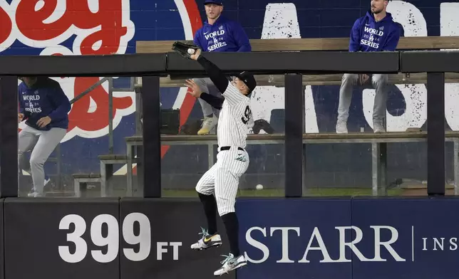 New York Yankees center fielder Aaron Judge catches a fly ball by Los Angeles Dodgers' Freddie Freeman during the fourth inning in Game 5 of the baseball World Series, Wednesday, Oct. 30, 2024, in New York. (AP Photo/Seth Wenig)