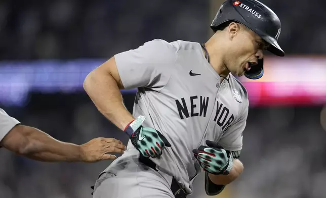 New York Yankees' Giancarlo Stanton runs the bases after hitting a two-run home run against the Los Angeles Dodgers during the sixth inning in Game 1 of the baseball World Series, Friday, Oct. 25, 2024, in Los Angeles. (AP Photo/Godofredo A. Vásquez)