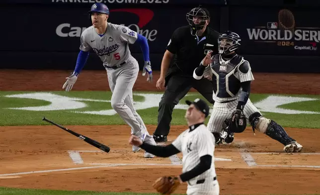 Los Angeles Dodgers' Freddie Freeman hits a two-run home run against the New York Yankees during the first inning in Game 3 of the baseball World Series, Monday, Oct. 28, 2024, in New York. (AP Photo/Frank Franklin II)