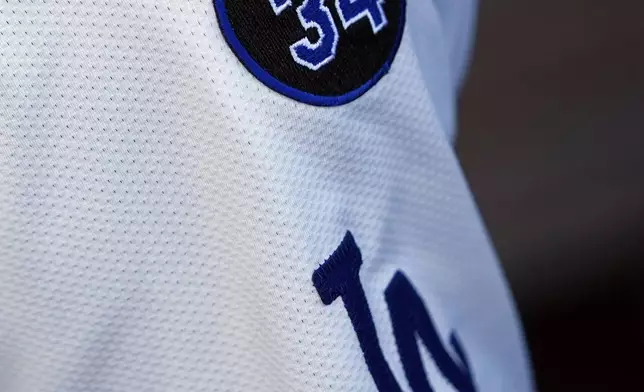 Los Angeles Dodgers' Andy Pages wears a patch on his jersey in memory of former Dodgers pitcher Fernando Valenzuela before Game 1 of the baseball World Series, Friday, Oct. 25, 2024, in Los Angeles. (AP Photo/Godofredo A. Vásquez)