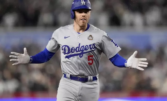 Los Angeles Dodgers' Freddie Freeman celebrates his two-run home run against the New York Yankees during the first inning in Game 4 of the baseball World Series, Tuesday, Oct. 29, 2024, in New York. (AP Photo/Ashley Landis)