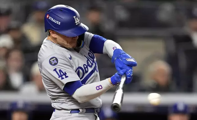 Los Angeles Dodgers' Kiké Hernández hits a RBI single against the New York Yankees during the sixth inning in Game 3 of the baseball World Series, Monday, Oct. 28, 2024, in New York. (AP Photo/Godofredo A. Vásquez)