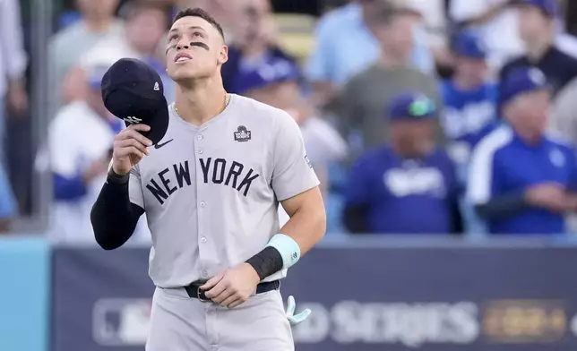 New York Yankees' Aaron Judge looks up in the outfield before Game 2 of the baseball World Series against the Los Angeles Dodgers, Saturday, Oct. 26, 2024, in Los Angeles. (AP Photo/Mark J. Terrill)