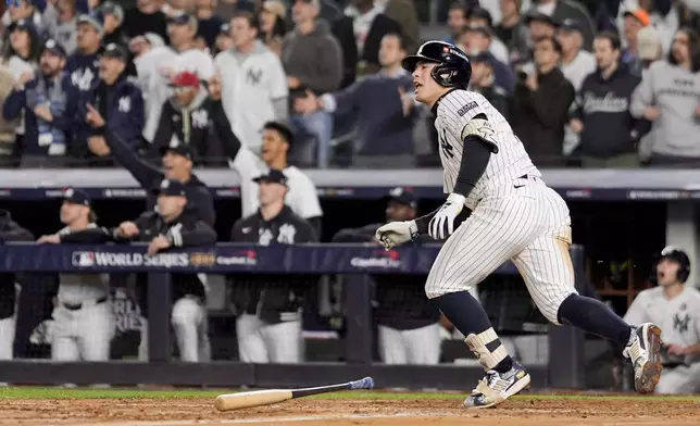 New York Yankees' Anthony Volpe celebrates his grand slam home run against the Los Angeles Dodgers during the third inning in Game 4 of the baseball World Series, Tuesday, Oct. 29, 2024, in New York. (AP Photo/Ashley Landis)