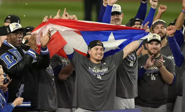 Los Angeles Dodgers' Kiké Hernández, center, celebrates with teammates after the Dodgers beat the New York Yankees in Game 5 to win the baseball World Series, Thursday, Oct. 31, 2024, in New York. (AP Photo/Seth Wenig)