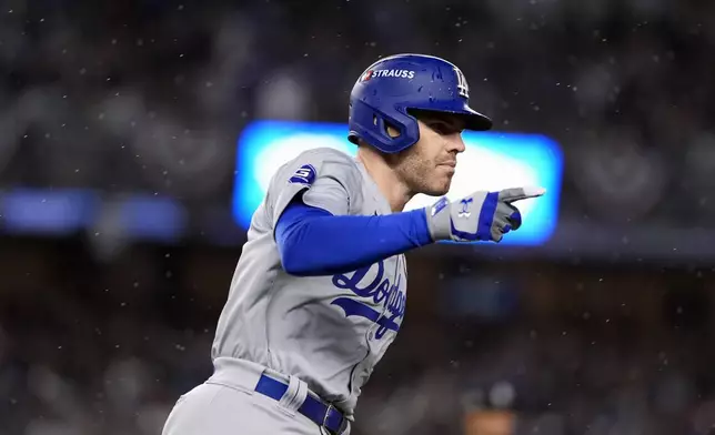 Los Angeles Dodgers' Freddie Freeman celebrates after hitting a two-run home run against the New York Yankees during the first inning in Game 4 of the baseball World Series, Tuesday, Oct. 29, 2024, in New York. (AP Photo/Godofredo A. Vásquez)