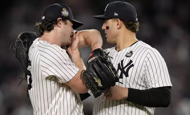 New York Yankees first baseman Anthony Rizzo (48) talks with starting pitcher Gerrit Cole during the fifth inning in Game 5 of the baseball World Series against the Los Angeles Dodgers, Wednesday, Oct. 30, 2024, in New York. (AP Photo/Ashley Landis)