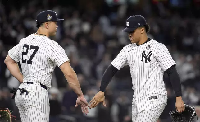 New York Yankees' Giancarlo Stanton (27) and Juan Soto celebrate after Game 4 of the baseball World Series against the Los Angeles Dodgers, Tuesday, Oct. 29, 2024, in New York. The Yankees won 11-4. (AP Photo/Godofredo A. Vásquez)