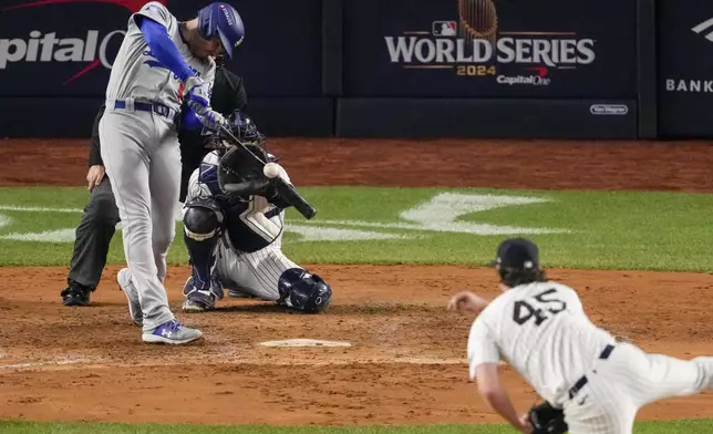 Los Angeles Dodgers' Freddie Freeman hits two RBI single during the fifth inning in Game 5 of the baseball World Series against the New York Yankees, Wednesday, Oct. 30, 2024, in New York. (AP Photo/Frank Franklin II)