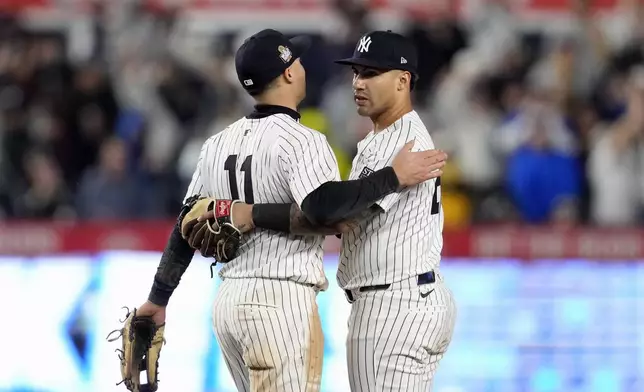 New York Yankees' Anthony Volpe (11) and Gleyber Torres celebrate after Game 4 of the baseball World Series against the Los Angeles Dodgers, Tuesday, Oct. 29, 2024, in New York. The Yankees won 11-4. (AP Photo/Godofredo A. Vásquez)