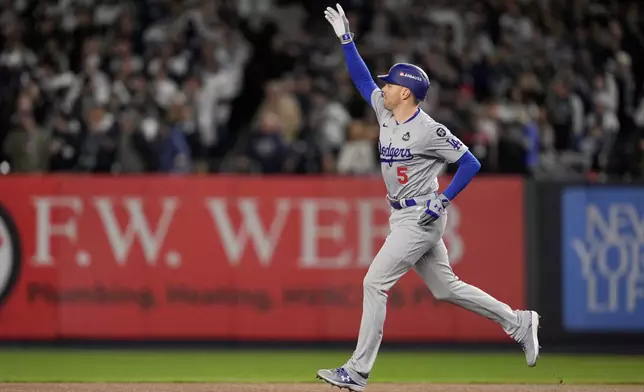 Los Angeles Dodgers' Freddie Freeman celebrates a two-run home run against the New York Yankees during the first inning in Game 3 of the baseball World Series, Monday, Oct. 28, 2024, in New York. (AP Photo/Ashley Landis)