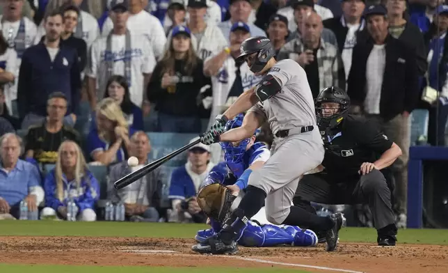 New York Yankees' Giancarlo Stanton connects for a two-run home during the sixth inning in Game 1 of the baseball World Series against the Los Angeles Dodgers, Friday, Oct. 25, 2024, in Los Angeles. (AP Photo/Mark J. Terrill)