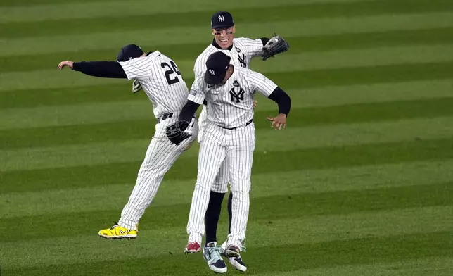 New York Yankees' Alex Verdugo (24), Aaron Judge and Juan Soto celebrate after Game 4 of the baseball World Series against the Los Angeles Dodgers, Tuesday, Oct. 29, 2024, in New York. The Yankees won 11-4. (AP Photo/Seth Wenig)