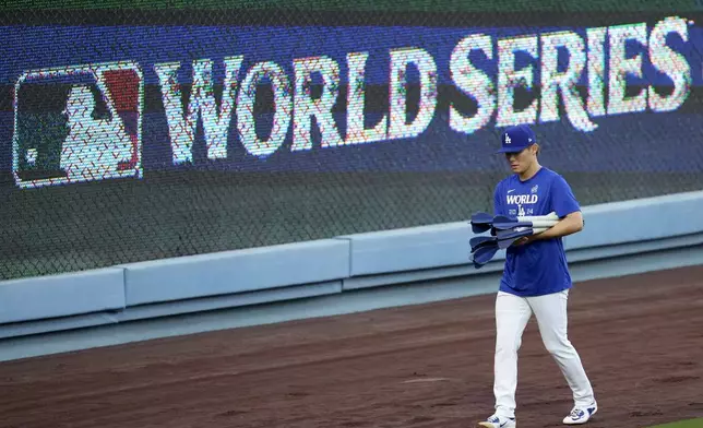 Los Angeles Dodgers pitcher Yoshinobu Yamamoto arrives during batting practice during media day for the baseball World Series against the New York Yankees, Thursday, Oct. 24, 2024, in Los Angeles. (AP Photo/Ashley Landis)