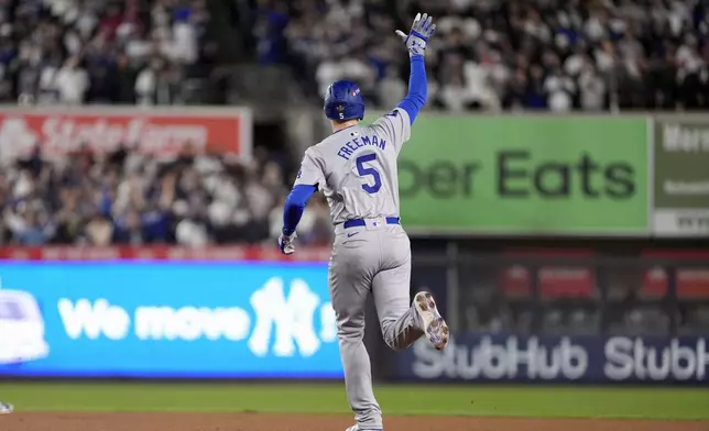 Los Angeles Dodgers' Freddie Freeman celebrates after hitting a two-run home run against the New York Yankees during the first inning in Game 4 of the baseball World Series, Tuesday, Oct. 29, 2024, in New York. (AP Photo/Godofredo A. Vásquez)