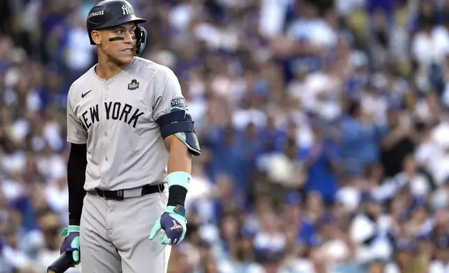 New York Yankees' Aaron Judge walks back to the dugout after striking out against the Los Angeles Dodgers during the first inning in Game 2 of the baseball World Series, Saturday, Oct. 26, 2024, in Los Angeles. (AP Photo/Godofredo A. Vásquez)