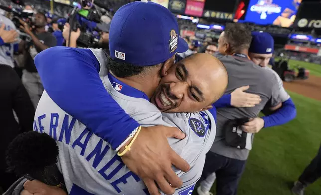 Los Angeles Dodgers' Freddie Freeman and Teoscar Hernández celebrate their win against the New York Yankees in Game 5 to win the baseball World Series, Wednesday, Oct. 30, 2024, in New York. (AP Photo/Ashley Landis)