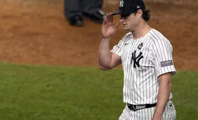 New York Yankees starting pitcher Gerrit Cole acknowledges the crowd as he leaves during the seventh inning in Game 5 of the baseball World Series against the Los Angeles Dodgers, Wednesday, Oct. 30, 2024, in New York. (AP Photo/Seth Wenig)