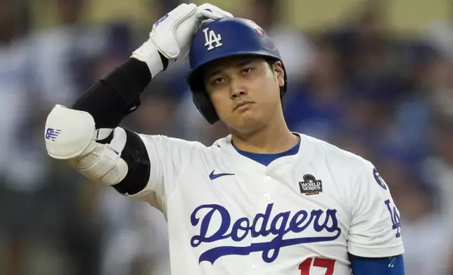 Los Angeles Dodgers' Shohei Ohtani reacts after striking out against the Los Angeles Dodgers during the third inning in Game 1 of the baseball World Series, Friday, Oct. 25, 2024, in Los Angeles. (AP Photo/Ashley Landis)