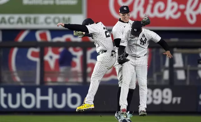 New York Yankees' Alex Verdugo, left, Aaron Judge, center, and Juan Soto celebrate after Game 4 of the baseball World Series against the Los Angeles Dodgers, Tuesday, Oct. 29, 2024, in New York. The Yankees won 11-4. (AP Photo/Godofredo A. Vásquez)