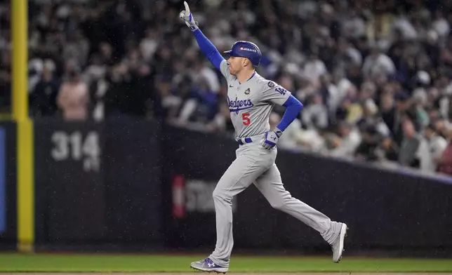 Los Angeles Dodgers' Freddie Freeman celebrates his two-run home run against the New York Yankees during the first inning in Game 4 of the baseball World Series, Tuesday, Oct. 29, 2024, in New York. (AP Photo/Ashley Landis)