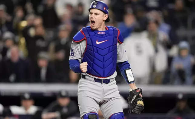 Los Angeles Dodgers catcher Will Smith celebrates after tagging New York Yankees' out at home during the fourth inning in Game 3 of the baseball World Series, Monday, Oct. 28, 2024, in New York. (AP Photo/Ashley Landis)