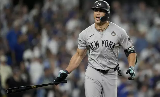 New York Yankees' Giancarlo Stanton celebrates his two-run home run against the Los Angeles Dodgers during the sixth inning in Game 1 of the baseball World Series, Friday, Oct. 25, 2024, in Los Angeles.(AP Photo/Ashley Landis)