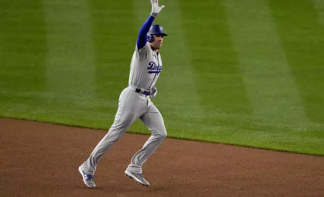 Los Angeles Dodgers' Freddie Freeman celebrates a two-run home run against the New York Yankees during the first inning in Game 3 of the baseball World Series, Monday, Oct. 28, 2024, in New York. (AP Photo/Frank Franklin II)