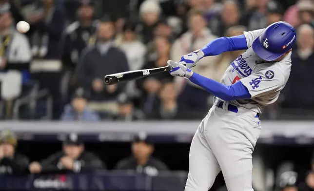 Los Angeles Dodgers' Freddie Freeman hits a two-run home run against the New York Yankees during the first inning in Game 3 of the baseball World Series, Monday, Oct. 28, 2024, in New York. (AP Photo/Ashley Landis)