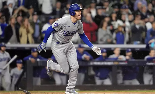 Los Angeles Dodgers' Freddie Freeman watches his two-run home run against the New York Yankees during the first inning in Game 4 of the baseball World Series, Tuesday, Oct. 29, 2024, in New York. (AP Photo/Godofredo A. Vásquez)