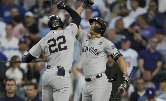 New York Yankees' Juan Soto celebrates his home run with Giancarlo Stanton during the third inning in Game 2 of the baseball World Series against the Los Angeles Dodgers, Saturday, Oct. 26, 2024, in Los Angeles. (AP Photo/Ashley Landis)