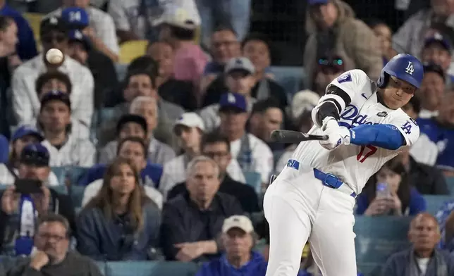 Los Angeles Dodgers' Shohei Ohtani connects for a double during the eighth inning in Game 1 of the baseball World Series against the New York Yankees, Friday, Oct. 25, 2024, in Los Angeles. (AP Photo/Mark J. Terrill)