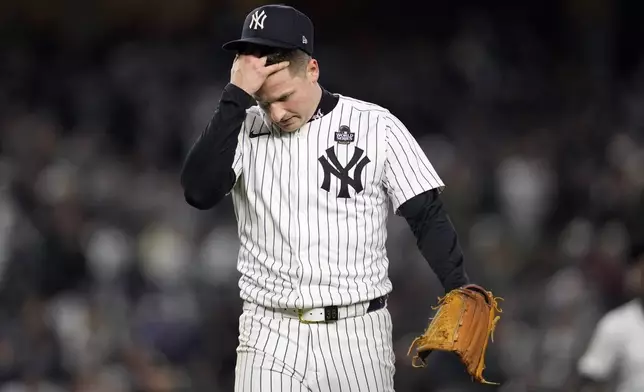 New York Yankees starting pitcher Clarke Schmidt walks back to the dugout after throwing against the Los Angeles Dodgers during the second inning in Game 3 of the baseball World Series, Monday, Oct. 28, 2024, in New York. (AP Photo/Godofredo A. Vásquez)