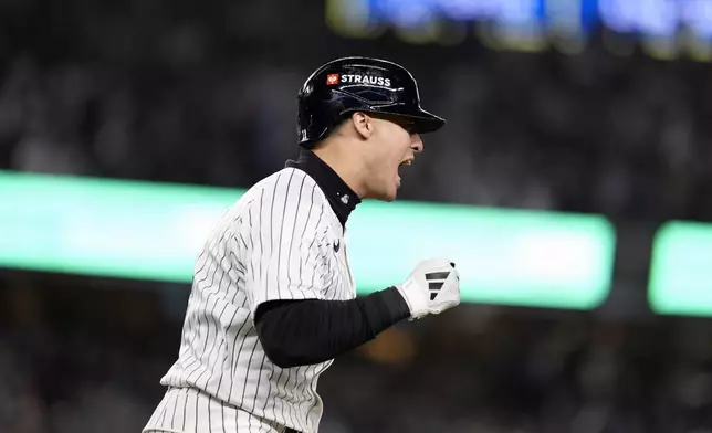 New York Yankees' Anthony Volpe celebrates after hitting a grand slam against the Los Angeles Dodgers during the third inning in Game 4 of the baseball World Series, Tuesday, Oct. 29, 2024, in New York. (AP Photo/Godofredo A. Vásquez)