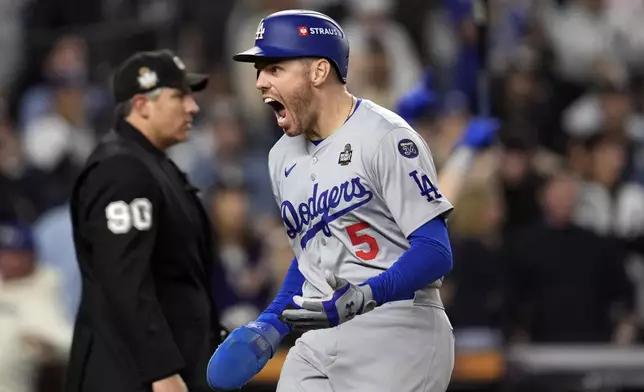 Los Angeles Dodgers' Freddie Freeman reacts after scoring against the New York Yankees during the fifth inning in Game 5 of the baseball World Series, Wednesday, Oct. 30, 2024, in New York. (AP Photo/Godofredo A. Vásquez)