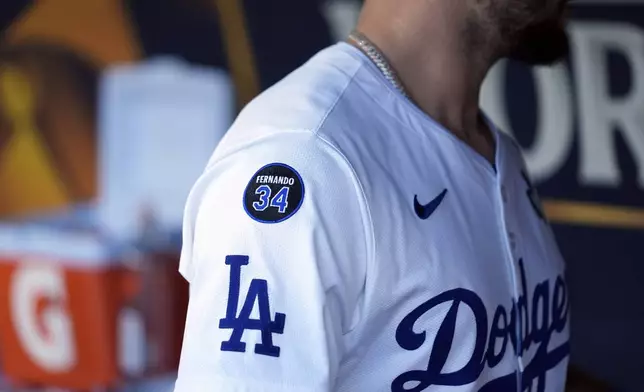 Los Angeles Dodgers' Andy Pages wears a patch on his jersey in memory of former Dodgers pitcher Fernando Valenzuela before Game 1 of the baseball World Series, Friday, Oct. 25, 2024, in Los Angeles. (AP Photo/Godofredo A. Vásquez)