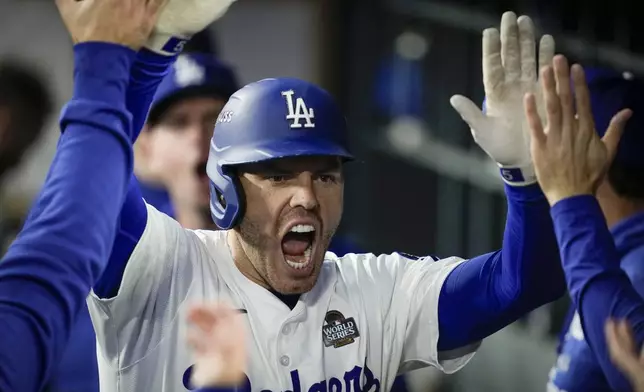 Los Angeles Dodgers' Freddie Freeman celebrates his home run against the New York Yankees during the third inning in Game 2 of the baseball World Series, Saturday, Oct. 26, 2024, in Los Angeles. (AP Photo/Ashley Landis)