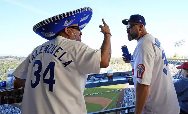 Los Angeles Dodgers fans wait for the start of Game 1 of the baseball World Series against the New York Yankees, Friday, Oct. 25, 2024, in Los Angeles. (AP Photo/Julio Cortez)