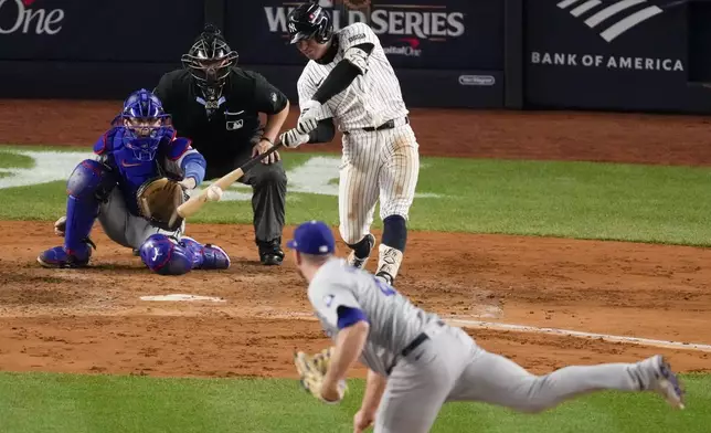 New York Yankees' Anthony Volpe hits a grand slam home run against the Los Angeles Dodgers during the third inning in Game 4 of the baseball World Series, Tuesday, Oct. 29, 2024, in New York. (AP Photo/Frank Franklin II)