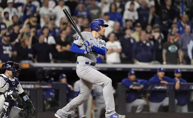 Los Angeles Dodgers' Freddie Freeman watches his two-run single against the New York Yankees during the fifth inning in Game 5 of the baseball World Series, Wednesday, Oct. 30, 2024, in New York. (AP Photo/Godofredo A. Vásquez)