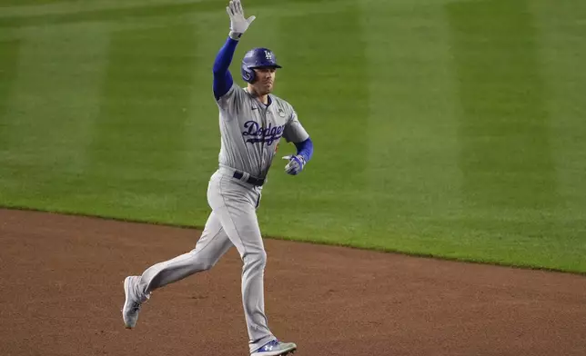 Los Angeles Dodgers' Freddie Freeman celebrates a two-run home run against the New York Yankees during the first inning in Game 4 of the baseball World Series, Tuesday, Oct. 29, 2024, in New York. (AP Photo/Frank Franklin II)