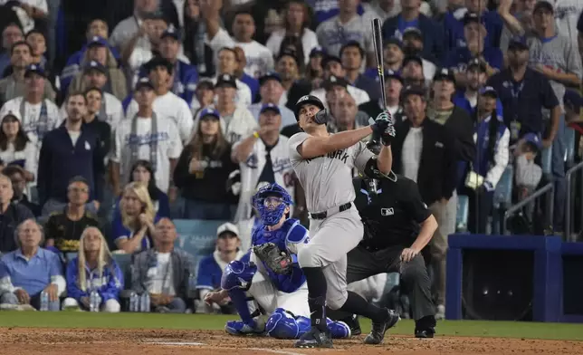 New York Yankees' Giancarlo Stanton watches his two-run home during the sixth inning in Game 1 of the baseball World Series against the Los Angeles Dodgers, Friday, Oct. 25, 2024, in Los Angeles. (AP Photo/Mark J. Terrill)