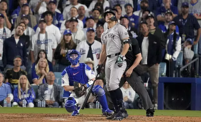 New York Yankees' Giancarlo Stanton watches his two-run home during the sixth inning in Game 1 of the baseball World Series against the Los Angeles Dodgers, Friday, Oct. 25, 2024, in Los Angeles. (AP Photo/Mark J. Terrill)