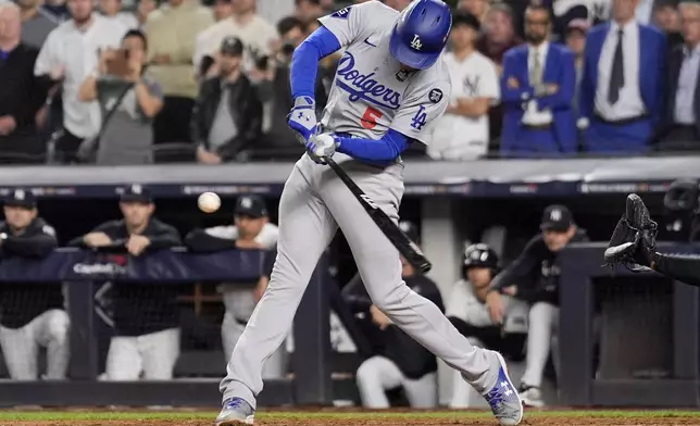 Los Angeles Dodgers' Freddie Freeman hits two RBI single during the fifth inning in Game 5 of the baseball World Series against the New York Yankees, Wednesday, Oct. 30, 2024, in New York. (AP Photo/Ashley Landis)