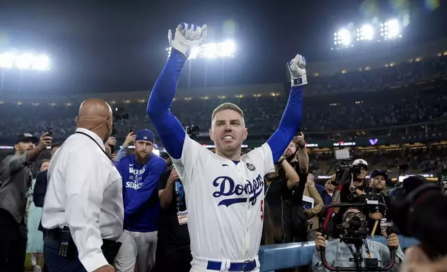 Los Angeles Dodgers' Freddie Freeman celebrates after hitting a game-winning grand slam against the New York Yankees during the 10th inning in Game 1 of the baseball World Series, Friday, Oct. 25, 2024, in Los Angeles. The Dodgers won 6-3. (AP Photo/Godofredo A. Vásquez)