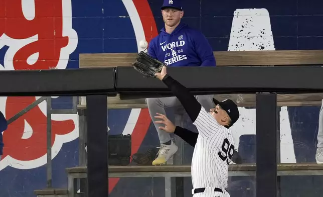 New York Yankees' Aaron Judge catches a fly ball by Los Angeles Dodgers' Freddie Freeman during the fourth inning in Game 5 of the baseball World Series, Wednesday, Oct. 30, 2024, in New York. (AP Photo/Seth Wenig)