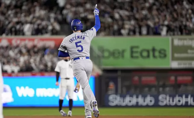 Los Angeles Dodgers' Freddie Freeman (5) celebrates after hitting a two-run home run against the New York Yankees during the first inning in Game 3 of the baseball World Series, Monday, Oct. 28, 2024, in New York. (AP Photo/Godofredo A. Vásquez)