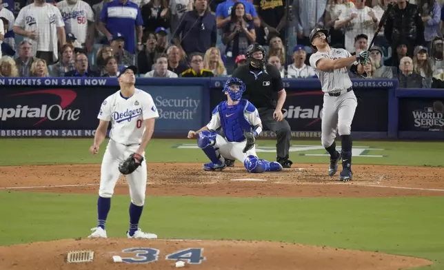 New York Yankees' Giancarlo Stanton watches his two-run home off Los Angeles Dodgers starting pitcher Jack Flaherty during the sixth inning in Game 1 of the baseball World Series, Friday, Oct. 25, 2024, in Los Angeles. (AP Photo/Mark J. Terrill)