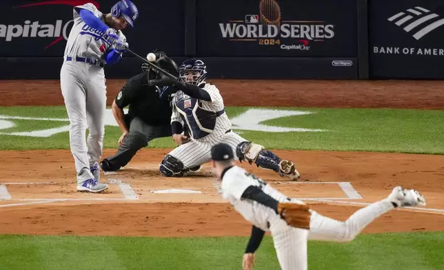 Los Angeles Dodgers' Freddie Freeman hits a two-run home run against the New York Yankees during the first inning in Game 3 of the baseball World Series, Monday, Oct. 28, 2024, in New York. (AP Photo/Frank Franklin II)