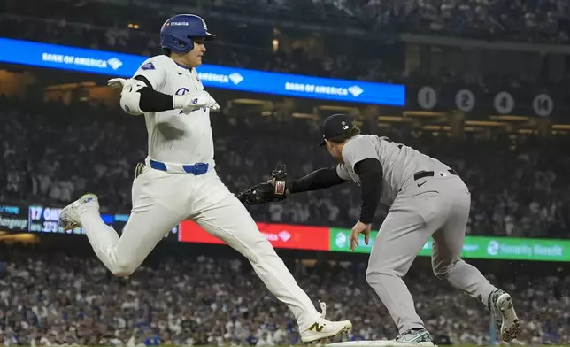 Los Angeles Dodgers' Shohei Ohtani is forced out at first by New York Yankees first baseman Anthony Rizzo during the sixth inning in Game 1 of the baseball World Series, Friday, Oct. 25, 2024, in Los Angeles. (AP Photo/Ashley Landis)